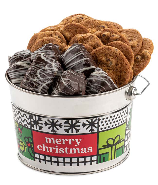  Festive 'Merry Christmas' tin bucket filled with 14 thin and crispy chocolate chip cookies and eight chocolate-drizzled brownies. The tin features cheerful holiday designs, making it a perfect Christmas gift.