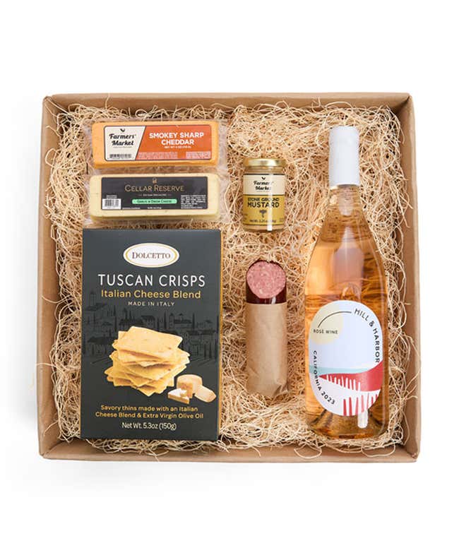 A gift box with a bottle of California Ros&eacute; Wine, two types of cheese, crackers, stone-ground mustard, and a summer sausage.