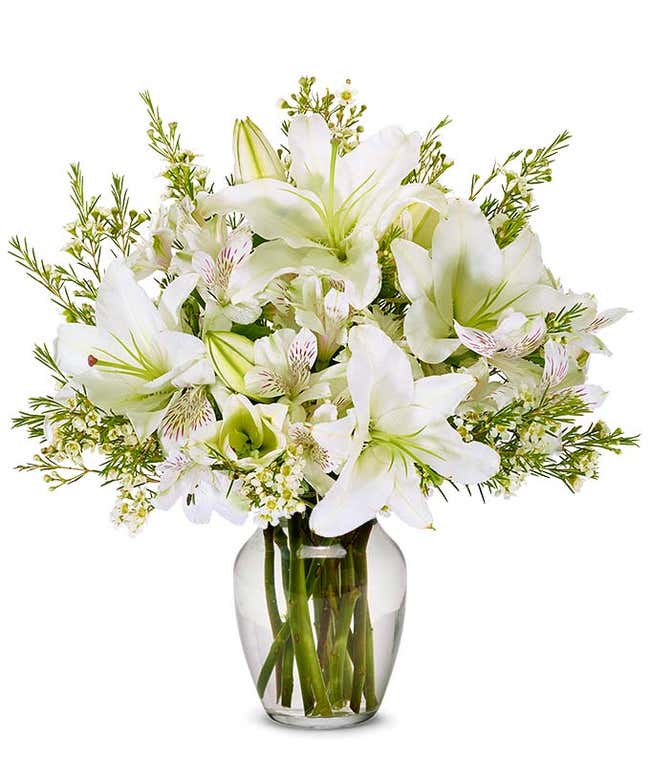 White lilies, white alstroemeria and white wax flowers