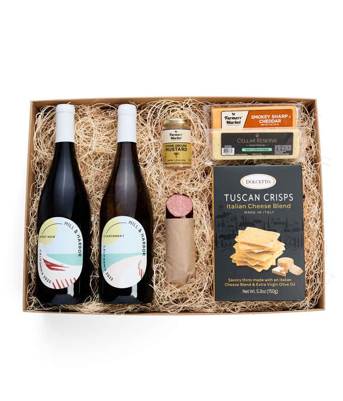 A gift box with two bottles of California wine - Pinot Noir and Chardonnay, two types of cheese, crackers, stone-ground mustard, and a summer sausage.