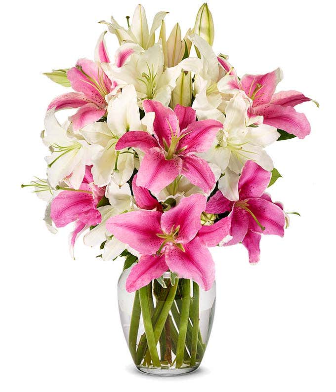 A bouquet featuring pink lilies and white lilies, with an optional glass vase.