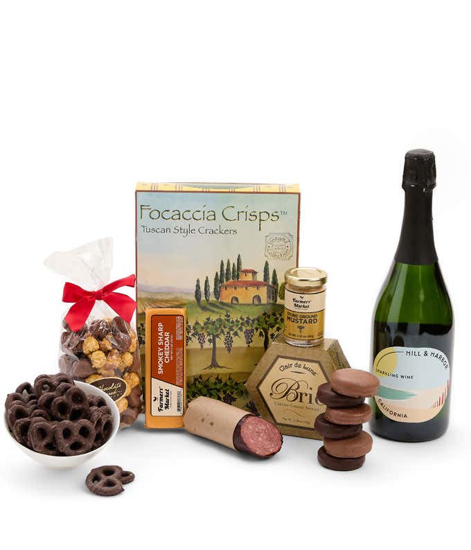 A gift set featuring a bottle of Hill & Harbor Sparkling Wine, focaccia crisps, 2 cheeses, mustard, summer sausage, caramel popcorn, chocolate pretzels, and 6 chocolate-covered Oreos for a sweet and savory gourmet experience.