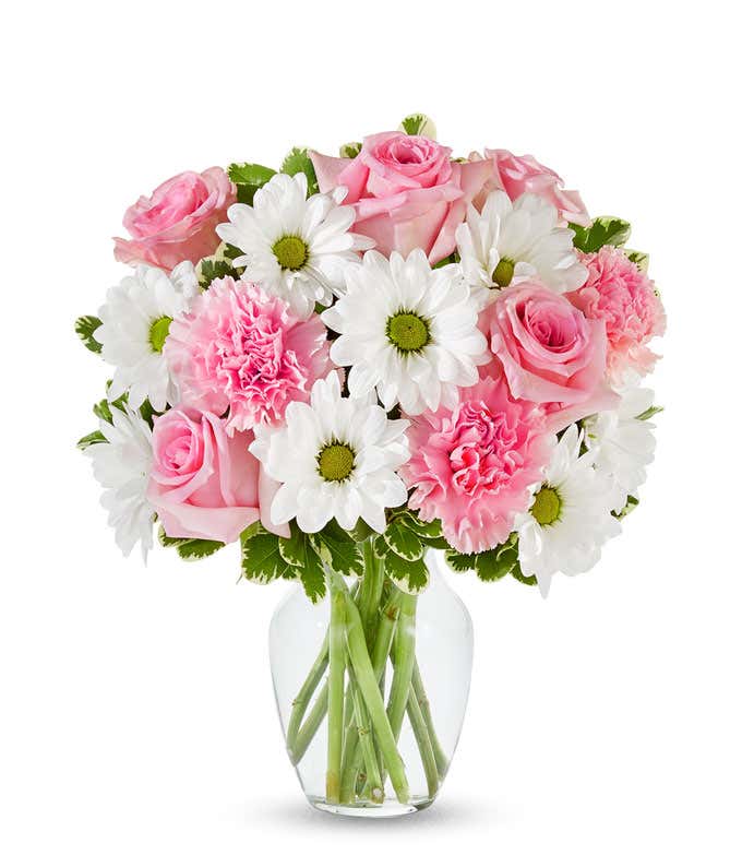 Pink roses, pink carnations and white daisies in a pink vase