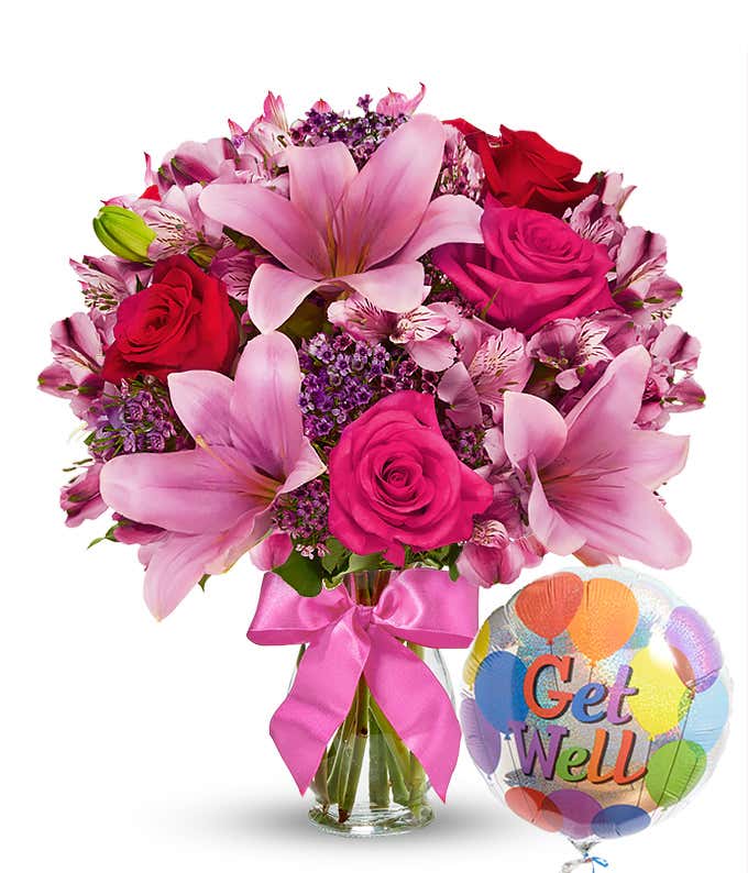 A cheerful arrangement featuring pink Asiatic lilies, pink and red roses, and alstroemeria, complemented by a Get Well mylar balloon. This vibrant display is perfect for brightening someone's day and comes in a glass vase with delivery available today.