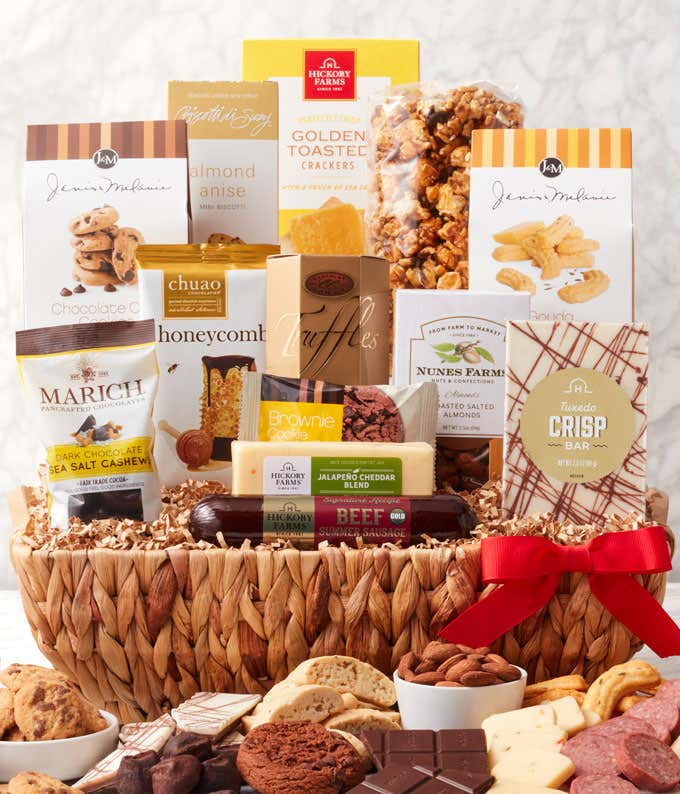 Woven gift basket with gourmet snacks: butter toffee pretzels, salted caramel popcorn, biscotti, toasted crackers, dark chocolate cashews, chocolate chip cookies, honeycomb chocolates, truffles, cheddar cheese, beef sausage, almonds, cheese straws, and a 