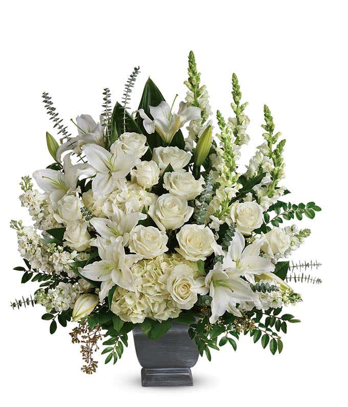 Funeral Arrangement: White hydrangeas, roses, snapdragons, stock flowers, and floral greenery in a Grey Modern Heritage Pot, symbolizing serenity and grace.